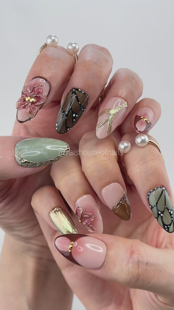 Video showing Rai's House of Nails fall 3D butterfly wing press on nails in motion, with the gold linework, filigree, and marbled details catching the light.