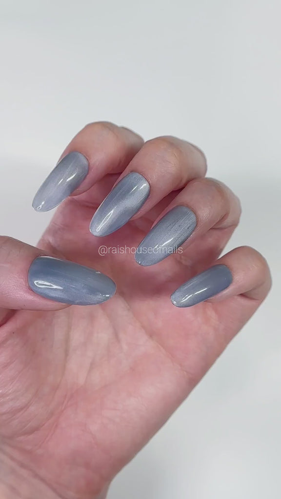 Video showing Blue gray velvet cat eye press on nails from the basic cat eye collection catching the light, round medium, by Rai's House of Nails.